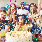 Confetti flying around group celebrating a party